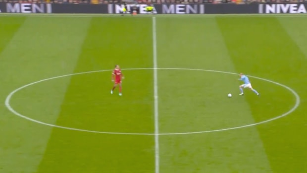 Erling Haaland pictured (right) running at Virgil van Dijk one-on-one during a Premier League game between Liverpool and Manchester City at Anfield in March 2024